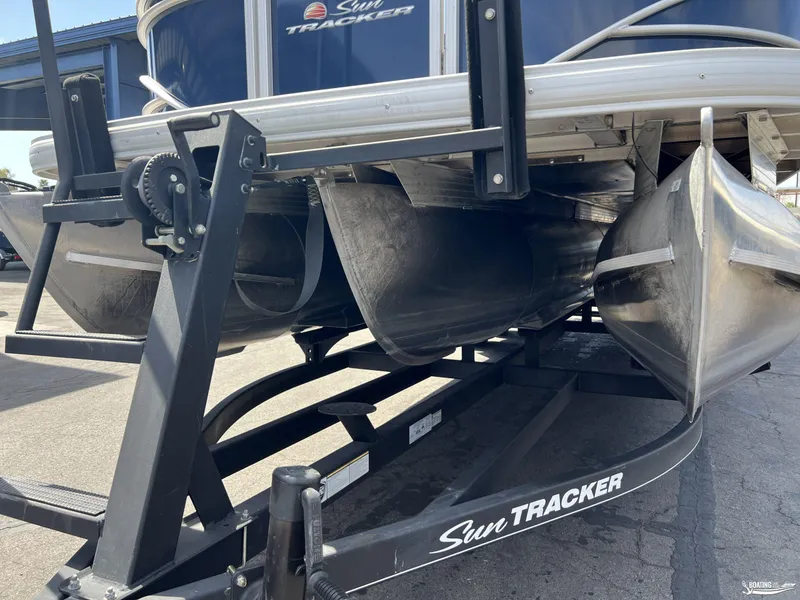 Slide: The Image of 2020 Sun Tracker Party Barge 24 DLX pontoon boat on trailer, close-up view. - 14