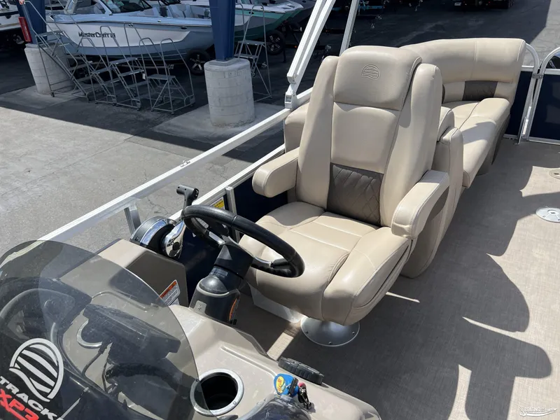 Slide: The Image of 2020 Sun Tracker Party Barge 24 DLX interior with beige captain's chair and steering wheel. - 5