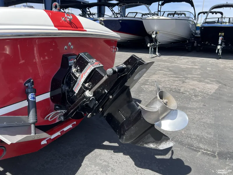 Slide: The Image of 1996 Donzi Sweet 16 boat with red and white exterior, featuring a powerful outboard motor. - 11