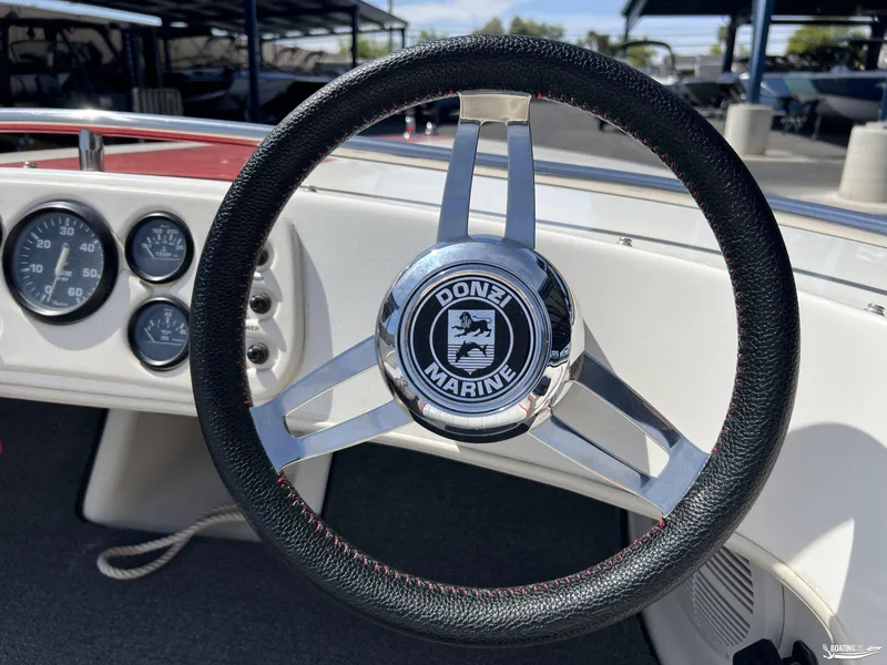 Slide: The Image of Steering wheel of a 1996 Donzi Sweet 16 boat with dashboard gauges. - 5