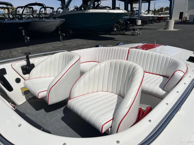 Slide: The Image of 1996 Donzi Sweet 16 boat interior with white and red-trimmed seats. - 6