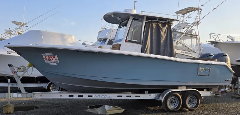 Slide: The Image of 2023 Sea Hunt Ultra 265 SE boat on trailer, displayed for sale. - 0