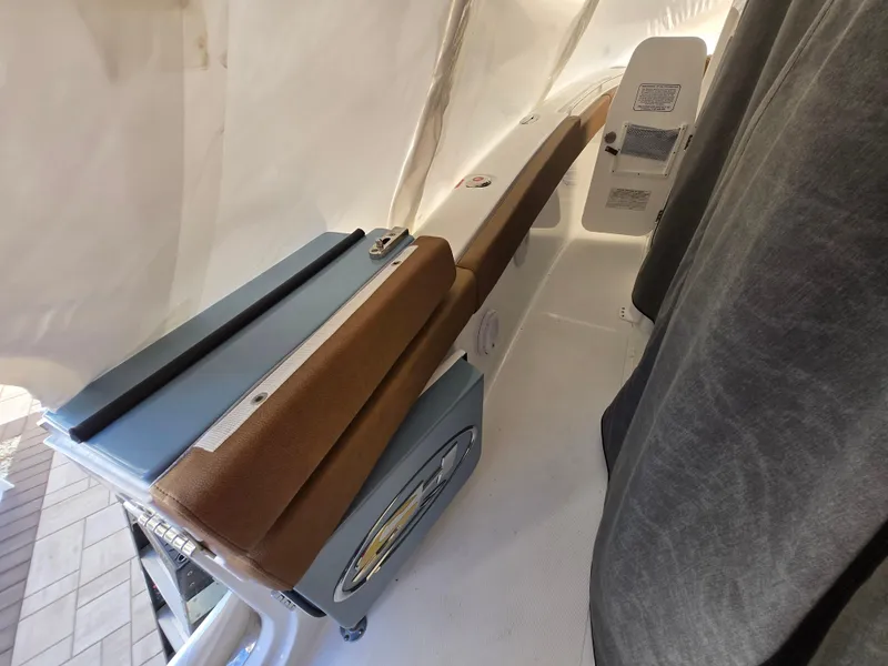 Slide: The Image of 2023 Sea Hunt Ultra 265 SE boat interior with cushioned seating and storage compartments. - 14
