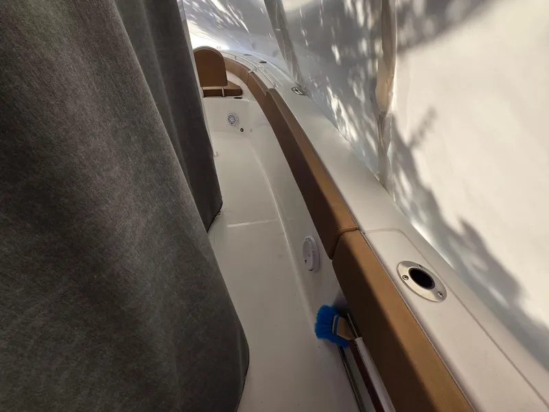 Slide: The Image of 2023 Sea Hunt Ultra 265 SE boat interior with brown and white seating. - 15