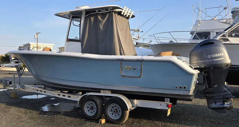 Slide: The Image of 2023 Sea Hunt Ultra 265 SE boat on trailer with Yamaha outboard motor. - 2