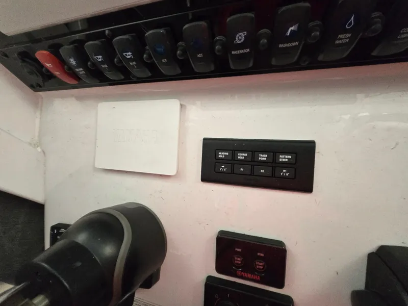 Slide: The Image of Control panel of 2023 Sea Hunt Ultra 265 SE boat with switches and throttle. - 20