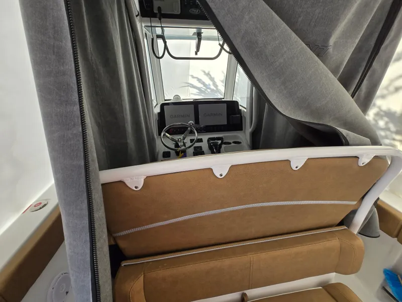Slide: The Image of 2023 Sea Hunt Ultra 265 SE boat interior with helm and navigation equipment. - 22