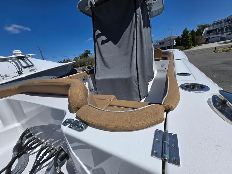 Slide: The Image of 2023 Sea Hunt Ultra 265 SE boat interior with tan seating and stainless steel fixtures. - 30