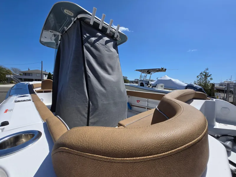 Slide: The Image of 2023 Sea Hunt Ultra 265 SE boat interior with tan seating and covered console. - 31