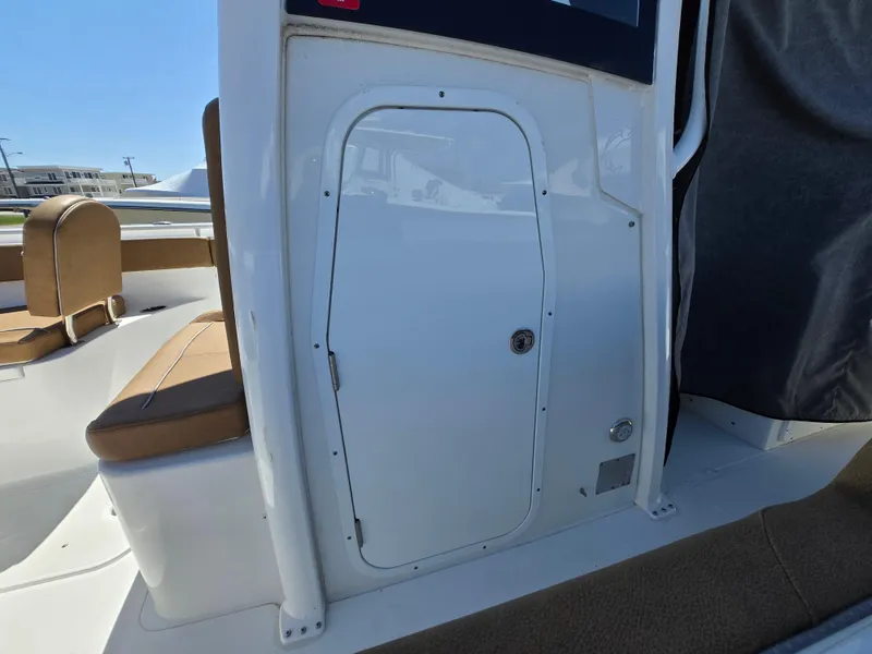 Slide: The Image of 2023 Sea Hunt Ultra 265 SE boat interior with seating and storage compartment. - 33