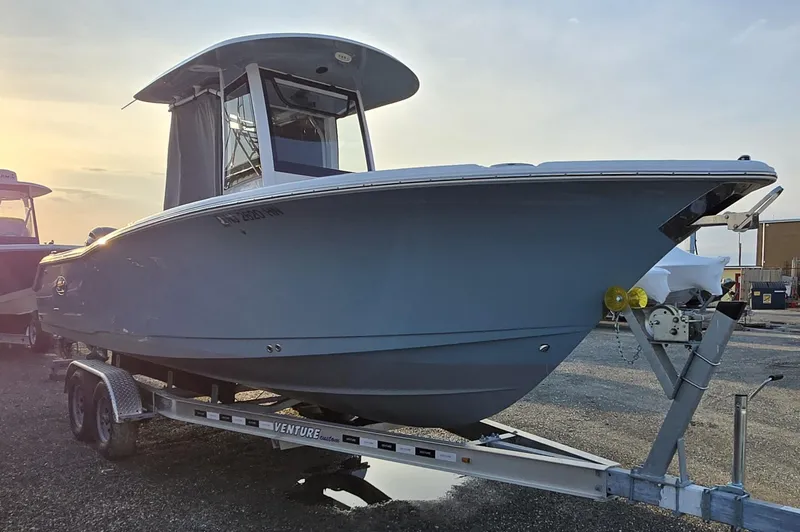 Slide: The Image of 2023 Sea Hunt Ultra 265 SE boat on trailer at sunset. - 9