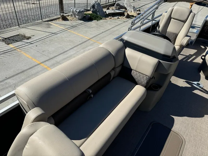 Slide: The Image of 2025 Sun Tracker 24 Sportfish XP3 pontoon boat with beige seating and spacious deck layout. - 13