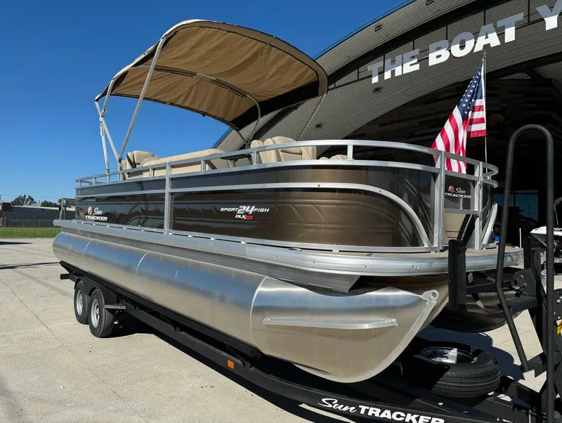 Slide: The Image of 2025 Sun Tracker 24 Sportfish XP3 pontoon boat with canopy, parked outdoors. - 4