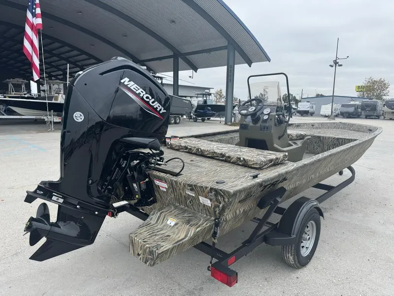 Slide: The Image of 2025 Tracker 1860 Grizzly boat with Mercury engine on trailer, parked outdoors. - 5