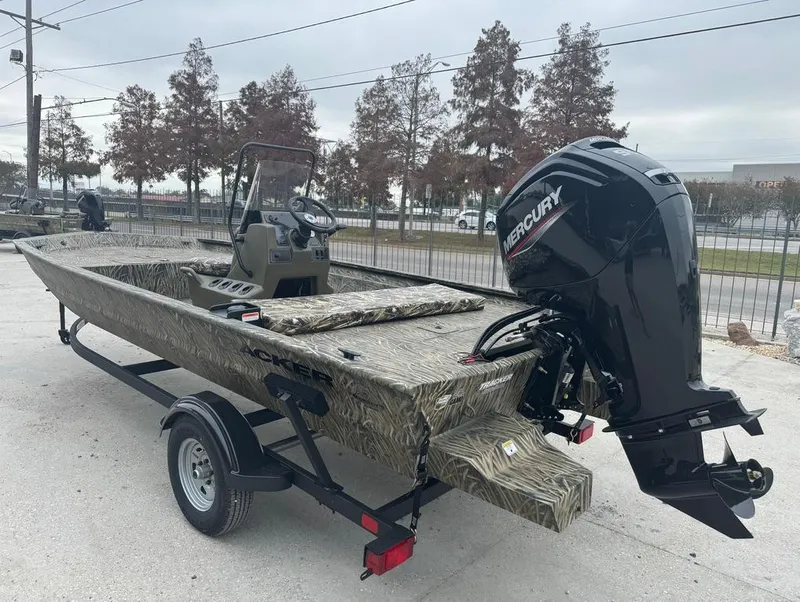 Slide: The Image of 2025 Tracker 1860 Grizzly boat with Mercury engine on trailer, outdoors. - 7