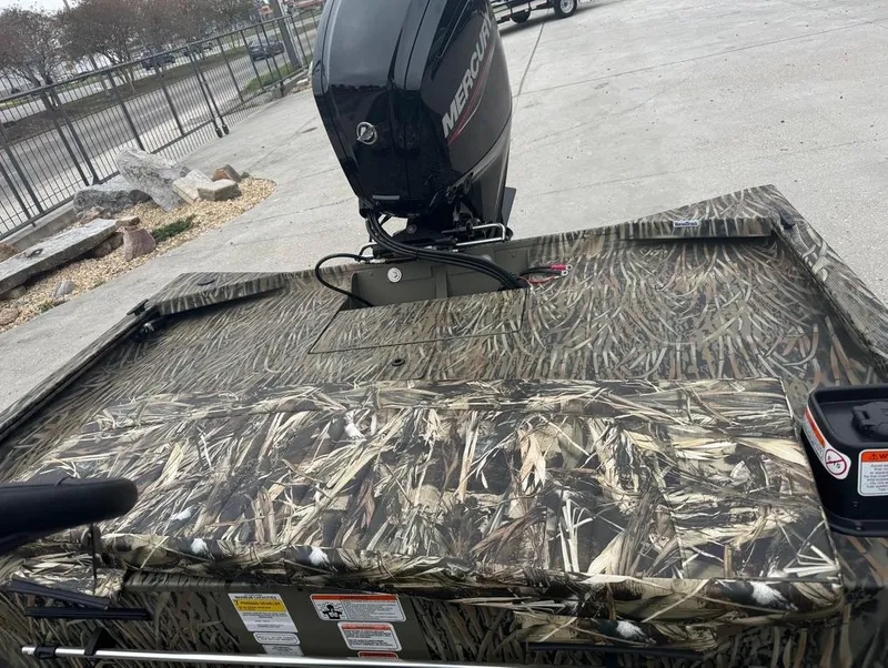 Slide: The Image of 2025 Tracker 1860 Grizzly boat with camo design and Mercury outboard motor. - 9