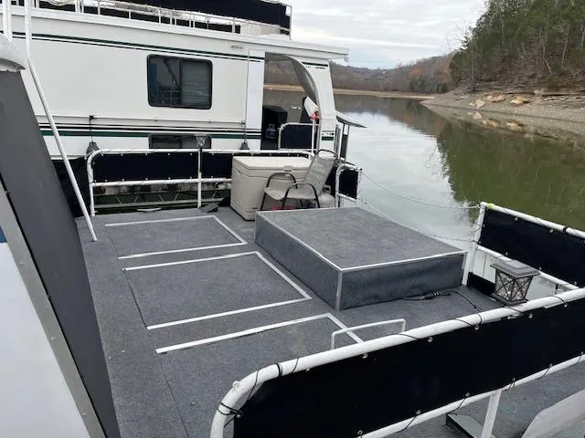 Slide: The Image of 1976 Sumerset houseboat with spacious deck on a serene lake. - 13