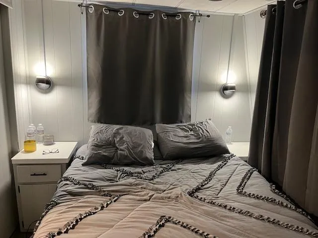 Slide: The Image of Cozy bedroom in 1976 Sumerset houseboat with modern lighting and neutral decor. - 3