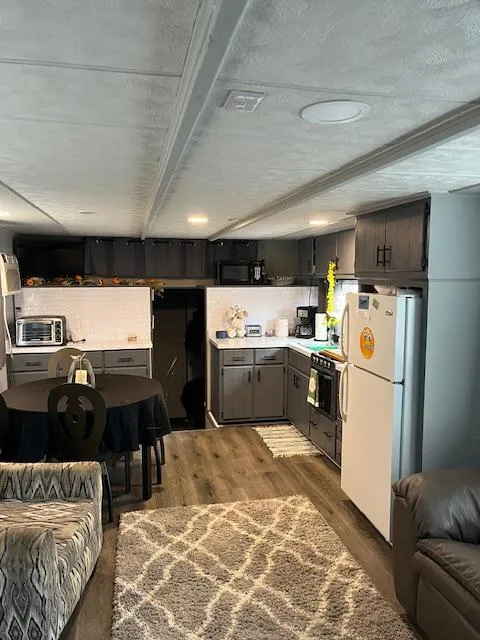 Slide: The Image of 1976 Sumerset houseboat interior with modern kitchen, dining area, and cozy living space. - 5