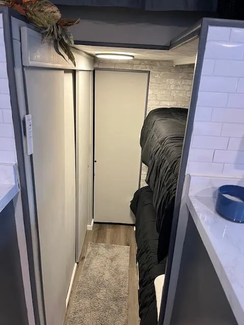 Slide: The Image of Narrow hallway in a 1976 Sumerset houseboat with modern decor and bunk beds. - 8