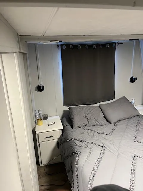 Slide: The Image of Cozy bedroom in 1976 Sumerset houseboat with gray bedding and curtains. - 9