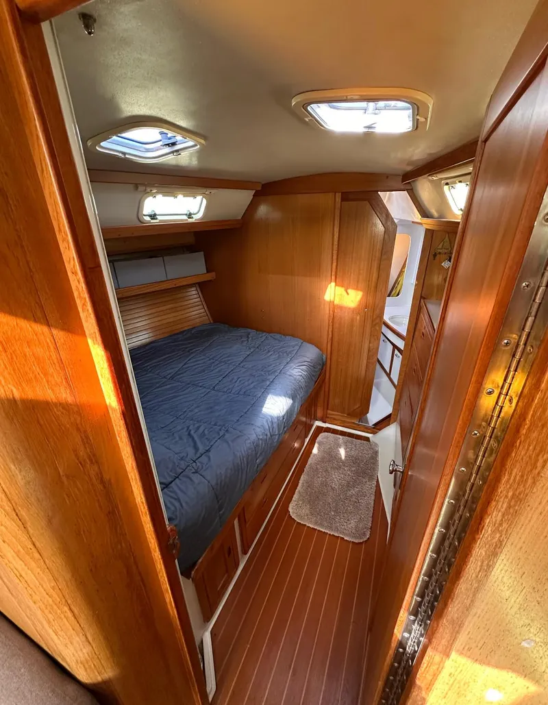 Slide: The Image of Cozy cabin interior of a 1993 Catalina 42 sailboat with wooden finishes and skylights. - 14