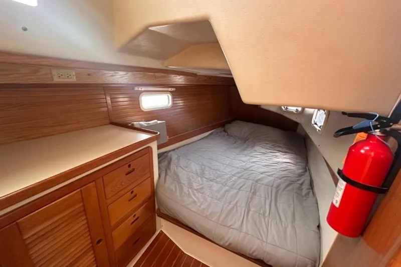 Slide: The Image of Cozy cabin interior of 1993 Catalina 42 sailboat with bed and wooden cabinetry. - 15