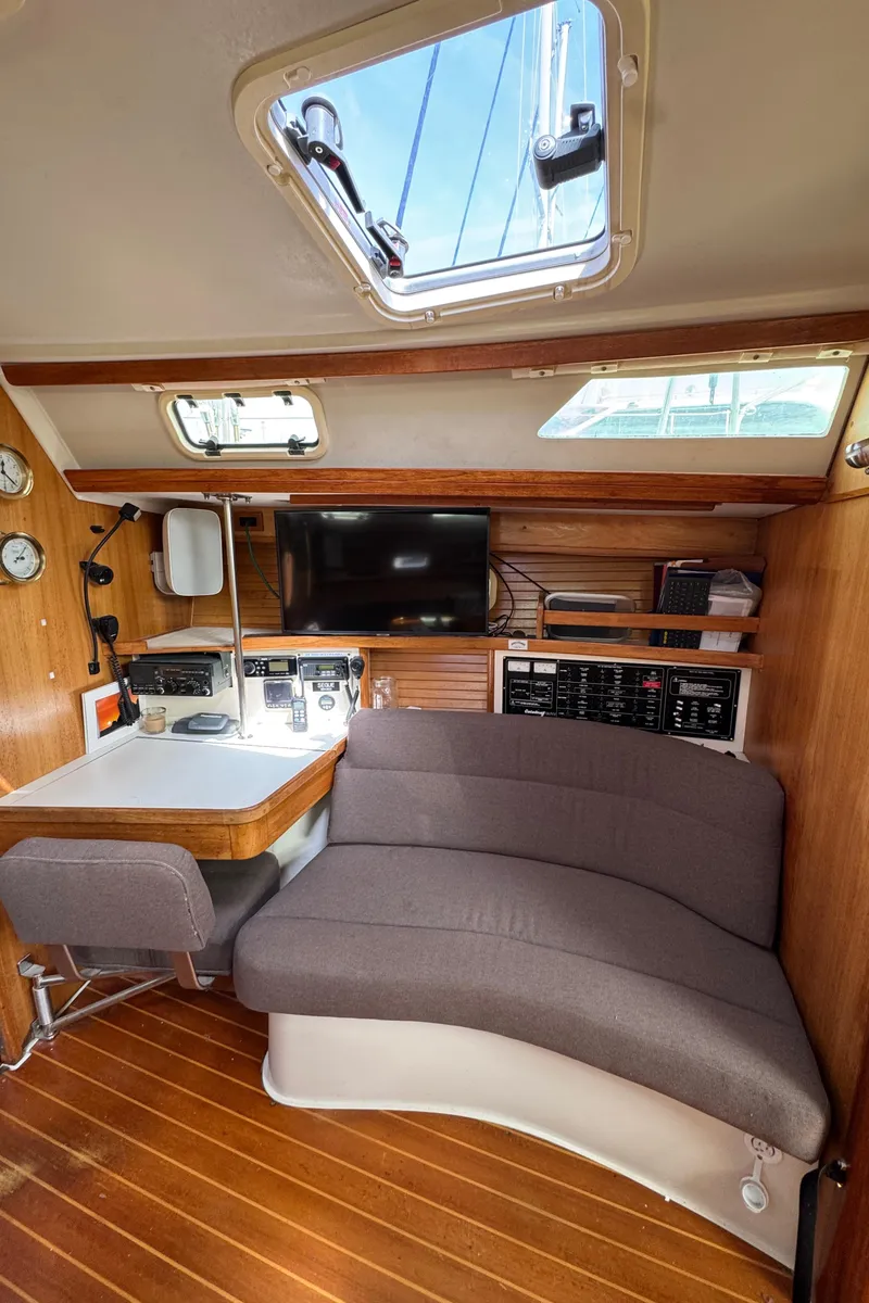 Slide: The Image of Interior of 1993 Catalina 42 sailboat with cozy seating and navigation station. - 16