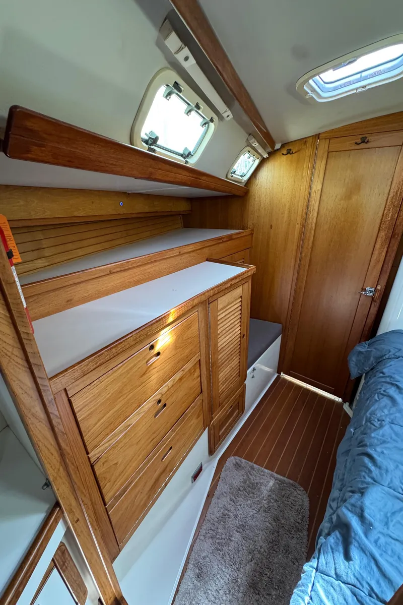 Slide: The Image of Interior of 1993 Catalina 42 sailboat with wooden cabinetry and cozy sleeping area. - 17
