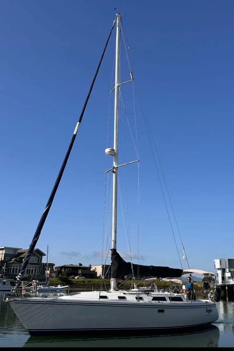 Slide: The Image of Catalina 42 sailboat from 1993 docked in a marina under clear blue skies. - 2