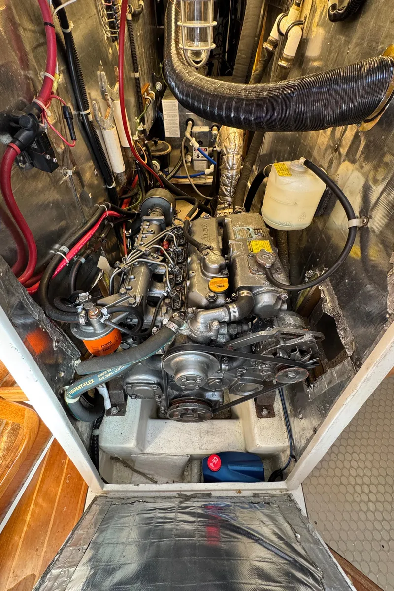 Slide: The Image of Engine compartment of a 1993 Catalina 42 sailboat, showcasing mechanical components and wiring. - 20