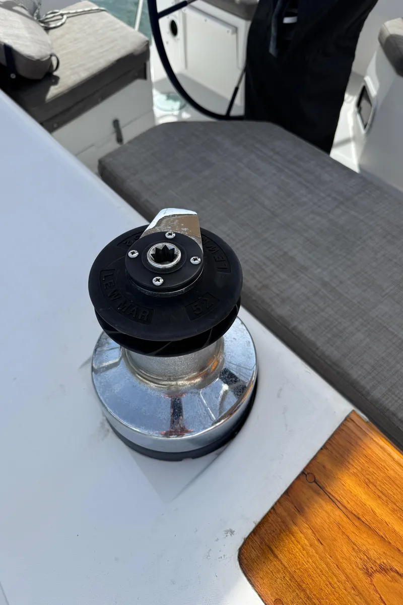 Slide: The Image of Winch on 1993 Catalina 42 sailboat deck, with seating and steering wheel visible. - 23