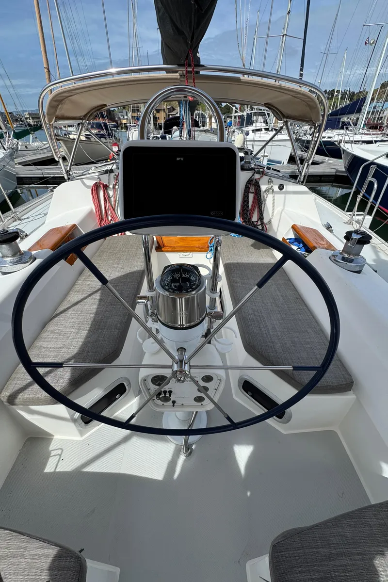 Slide: The Image of Cockpit of a 1993 Catalina 42 sailboat with steering wheel and navigation equipment. - 24