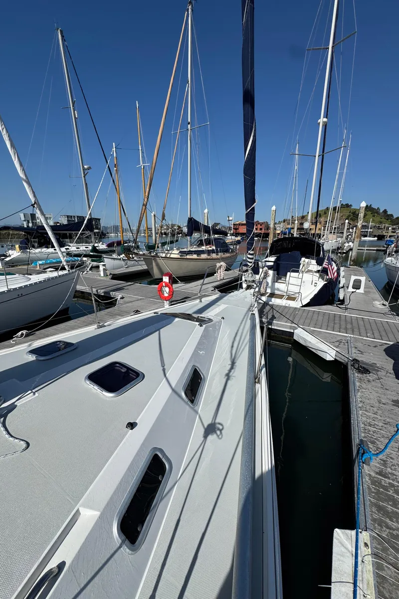 Slide: The Image of Sailboats docked at marina, featuring a 1993 Catalina 42 under clear blue skies. - 26