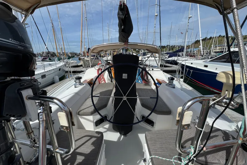 Slide: The Image of Cockpit view of a 1993 Catalina 42 sailboat docked in a marina. - 5