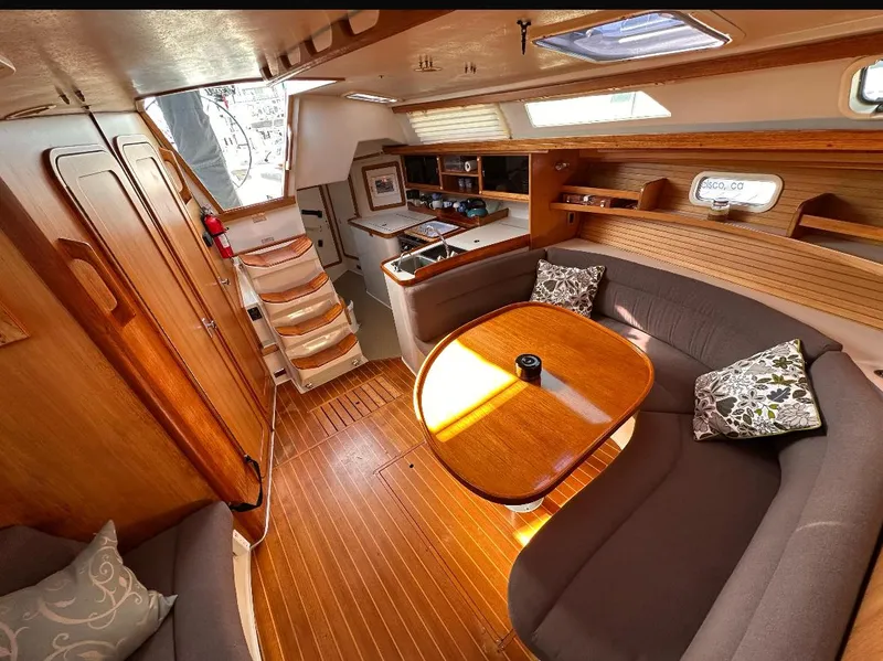Slide: The Image of Cozy interior of a 1993 Catalina 42 sailboat with wooden furnishings and a dining area. - 8