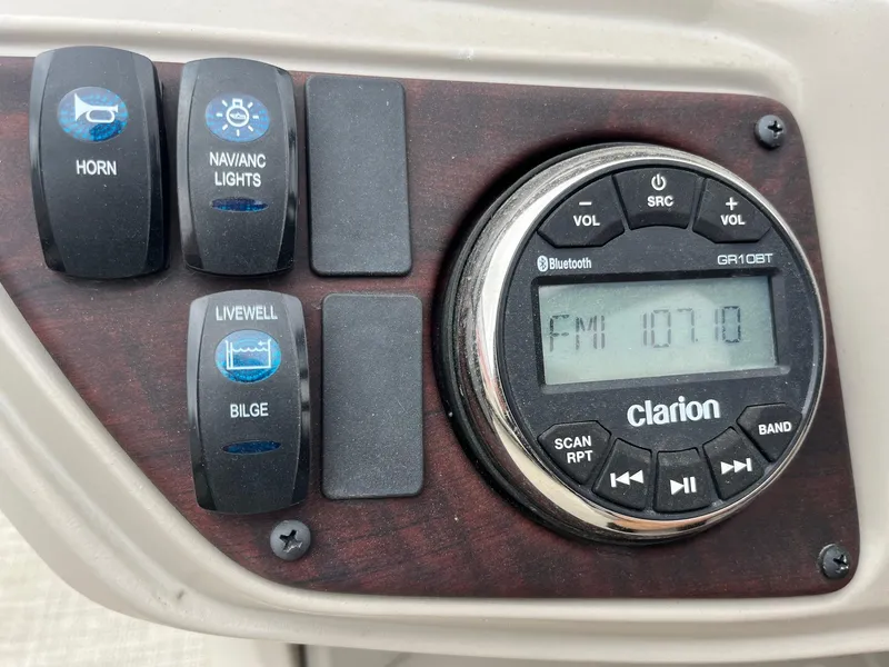 Slide: The Image of Control panel of 2022 Trifecta 22 LE Rear Fish with radio and switches. - 23