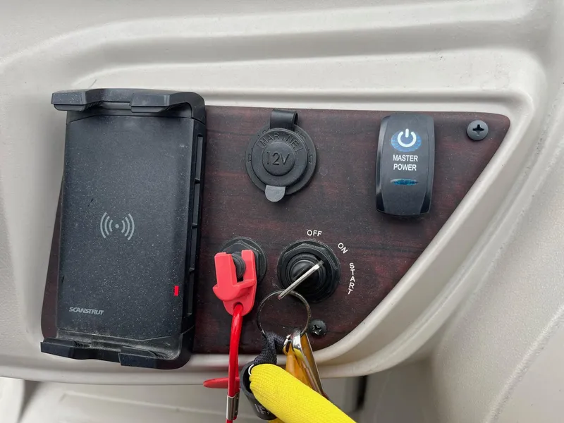 Slide: The Image of Control panel of 2022 Trifecta 22 LE Rear Fish with power switch and phone holder. - 24