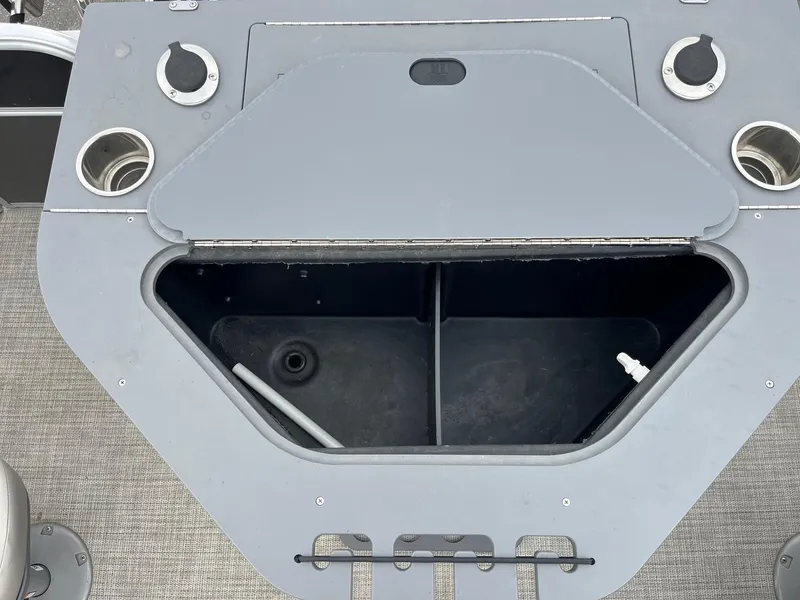 Slide: The Image of 2022 Trifecta 22 LE Rear Fish boat storage compartment with cup holders and fittings. - 26