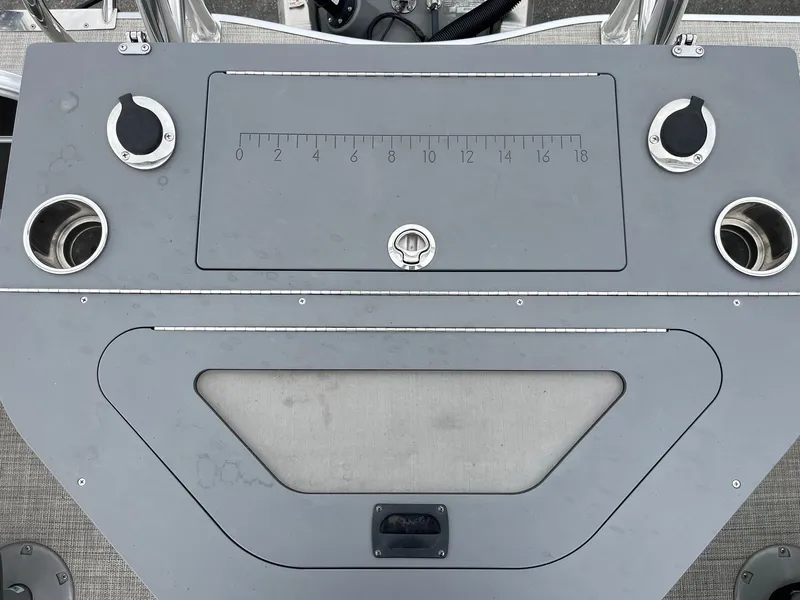 Slide: The Image of Control panel of 2022 Trifecta 22 LE Rear Fish boat with cup holders and measurement markings. - 28