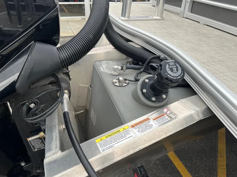 Slide: The Image of Fuel system of 2022 Trifecta 22 LE Rear Fish boat, showing hoses and warning labels. - 29