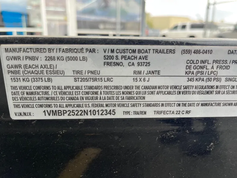 Slide: The Image of Label on Trifecta 22 LE Rear Fish boat trailer, detailing specifications and compliance information. - 32