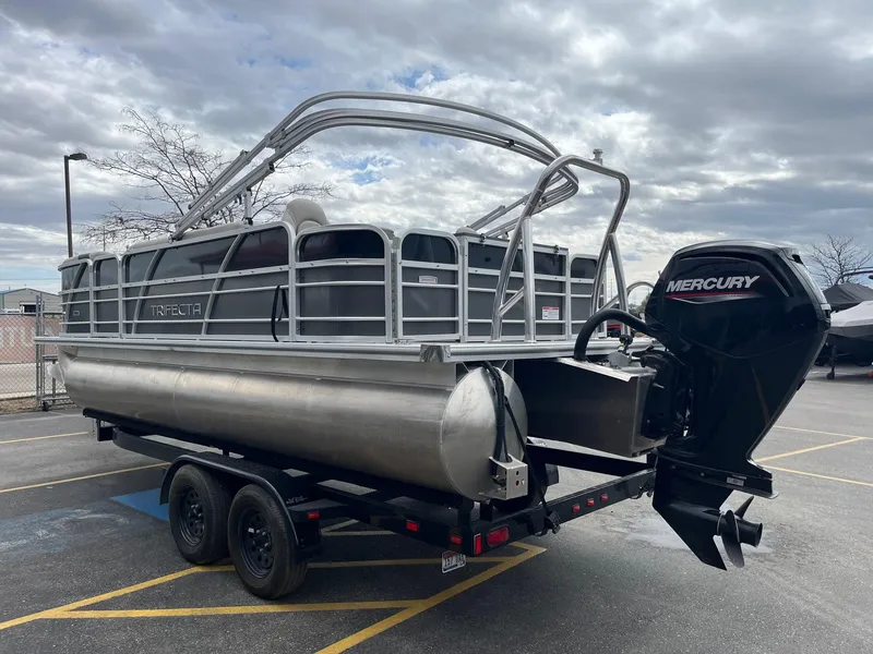 Slide: The Image of 2022 Trifecta 22 LE Rear Fish pontoon boat with Mercury outboard motor on trailer. - 6