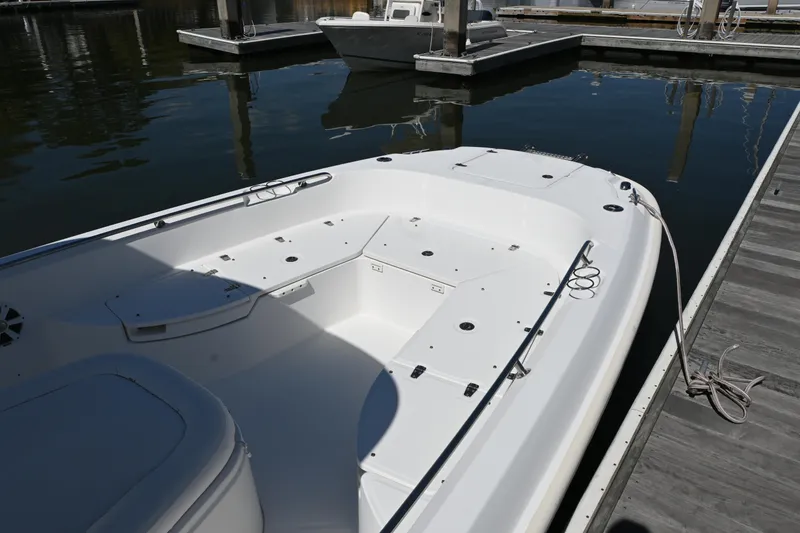 Slide: The Image of 2014 Boston Whaler 270 Dauntless boat docked at marina, showcasing spacious deck layout. - 11