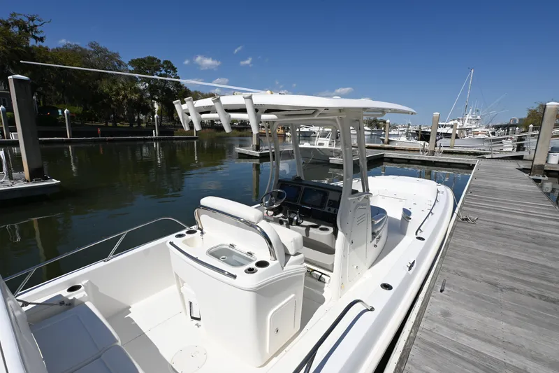 Slide: The Image of 2014 Boston Whaler 270 Dauntless boat docked at marina under clear blue sky. - 12