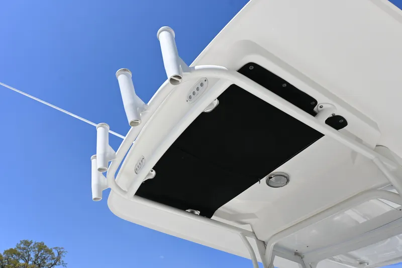 Slide: The Image of Boston Whaler 270 Dauntless 2014 boat roof with rod holders against blue sky. - 13