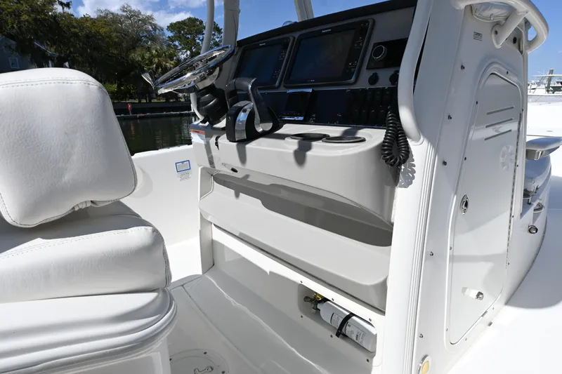 Slide: The Image of 2014 Boston Whaler 270 Dauntless boat console with steering wheel and controls. - 18