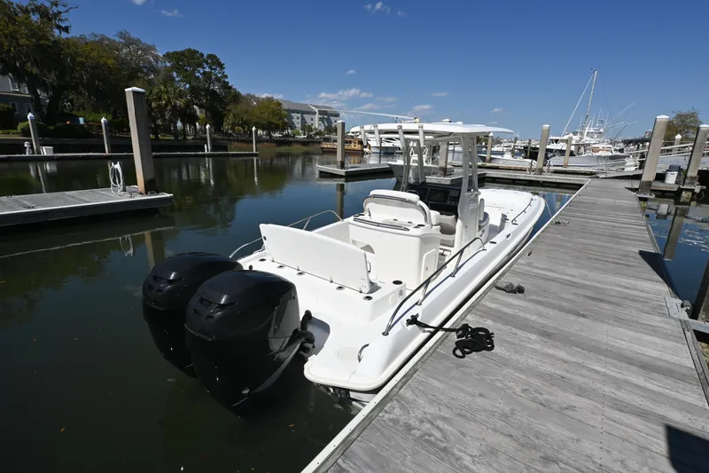 Slide: The Image of 2014 Boston Whaler 270 Dauntless docked at marina with twin engines. - 6