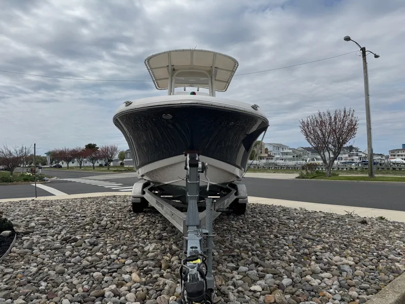 Slide: The Image of 2018 Robalo R200 Center Console boat on trailer, parked on gravel. - 2