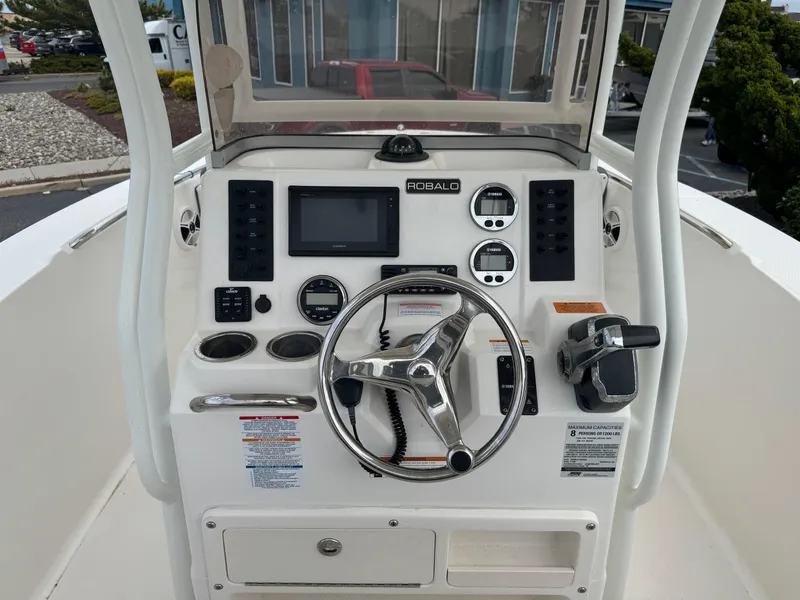 Slide: The Image of 2018 Robalo R200 Center Console boat dashboard with steering wheel and controls. - 7
